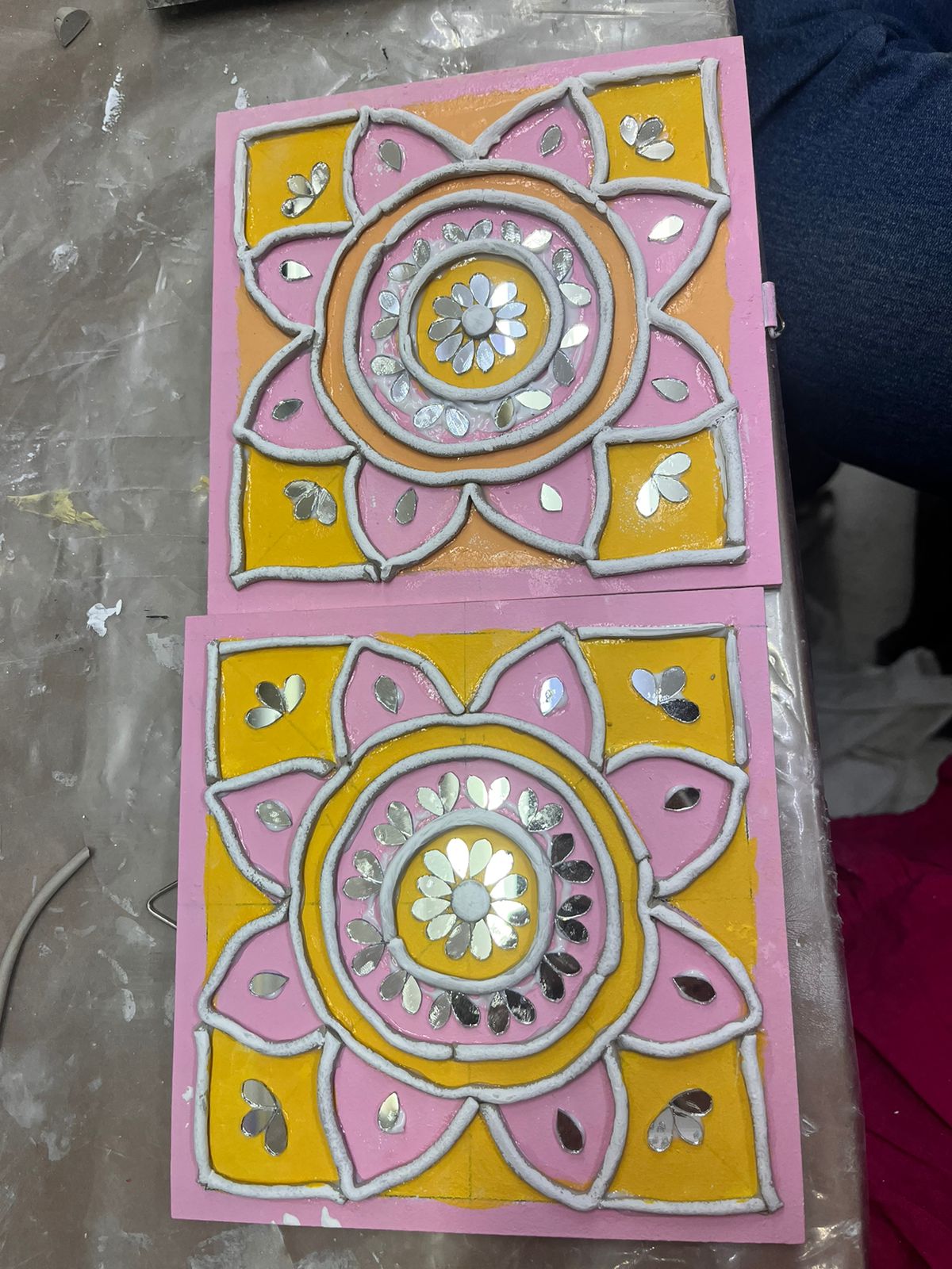 Mandalas in progress — clay and mirrors on a studio table