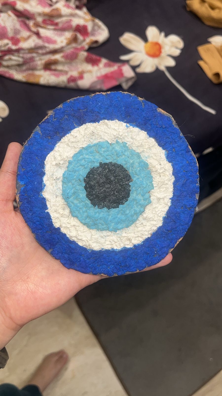 The Nazar in hand — close-up of the paper-pulp texture