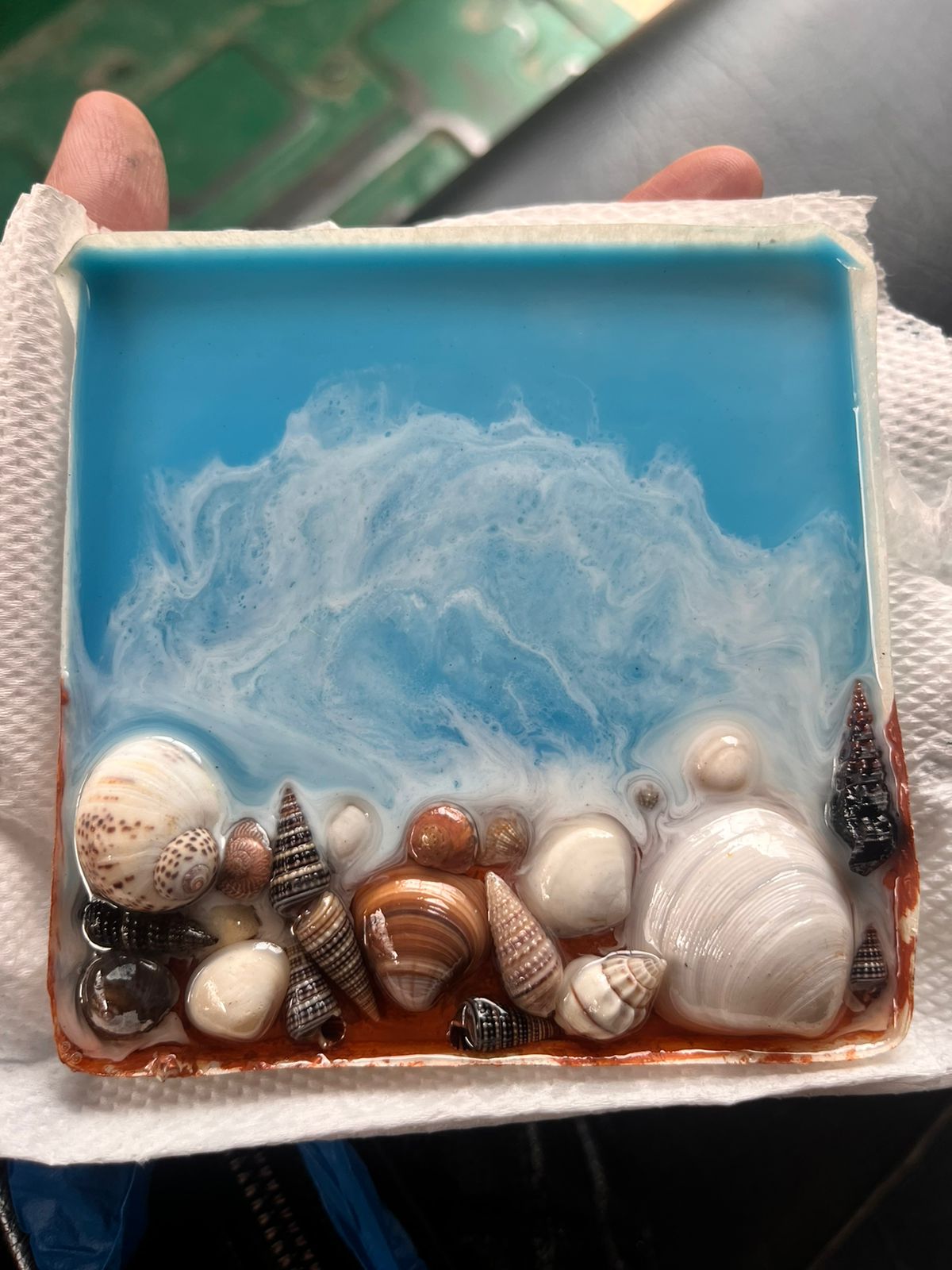 Detail of resin ocean — shells and milky waves